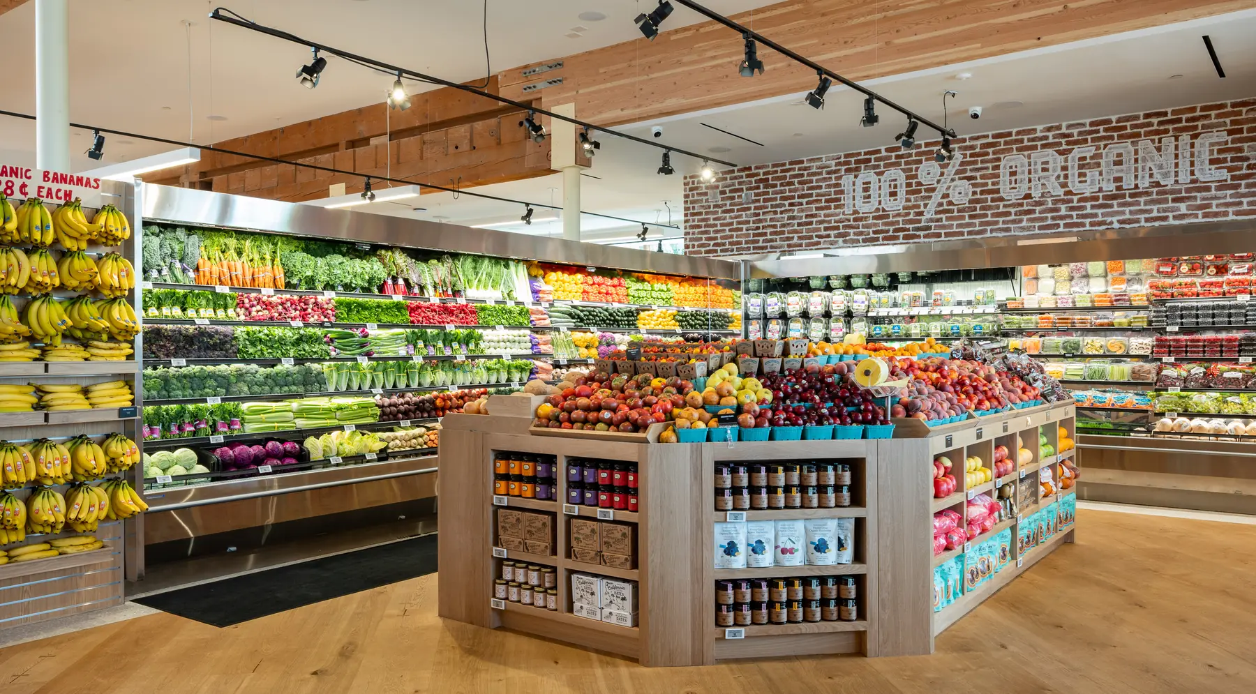 The organic produce wall beneath a 100% Organic sign