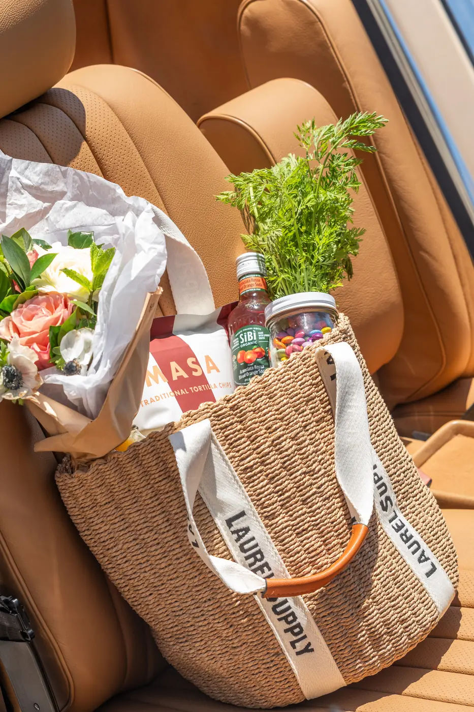 A Laurel Supply tote packed with flowers, herbs and groceries